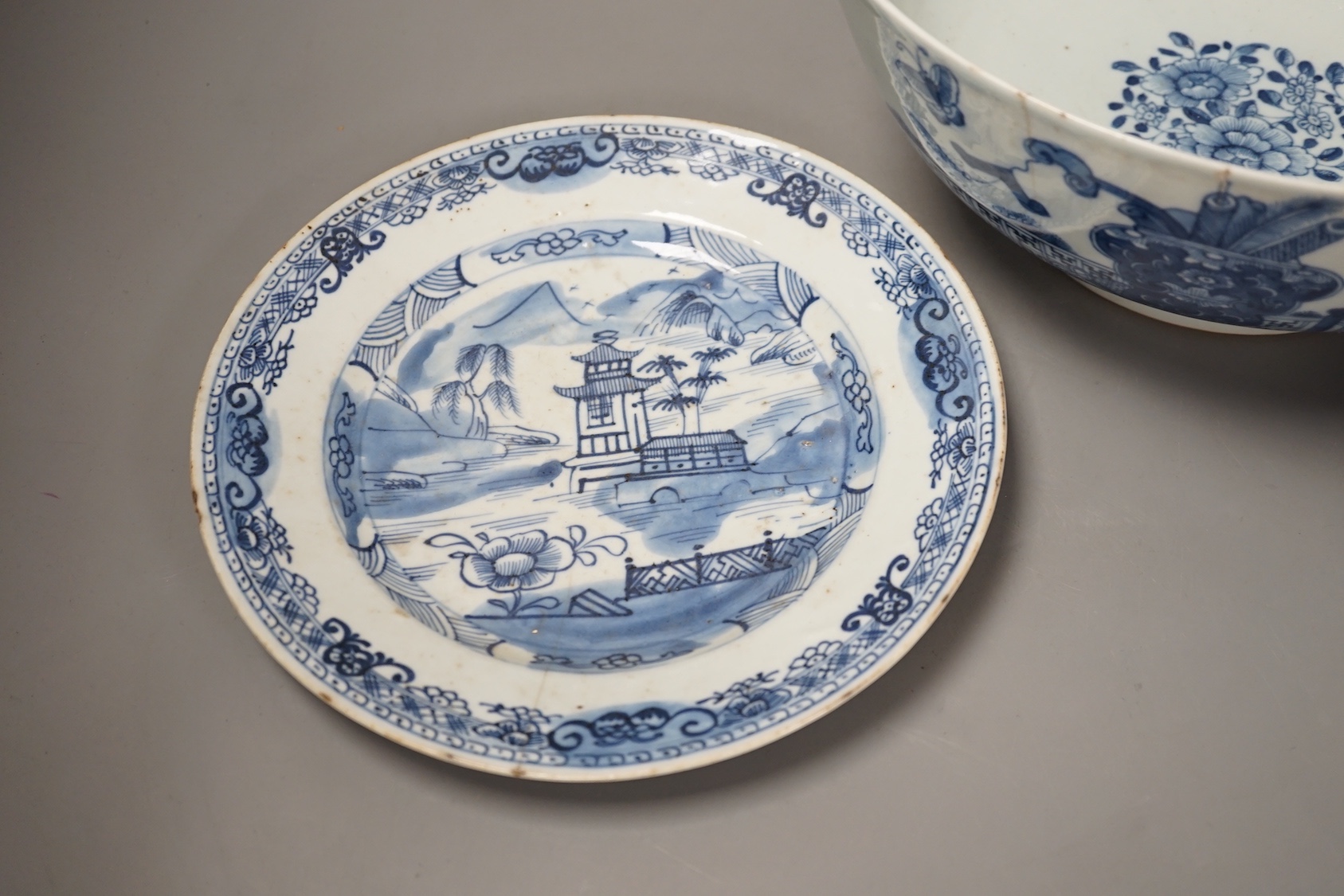 An 18th century Chinese blue and white punch bowl and similar plate. Largest 29cm